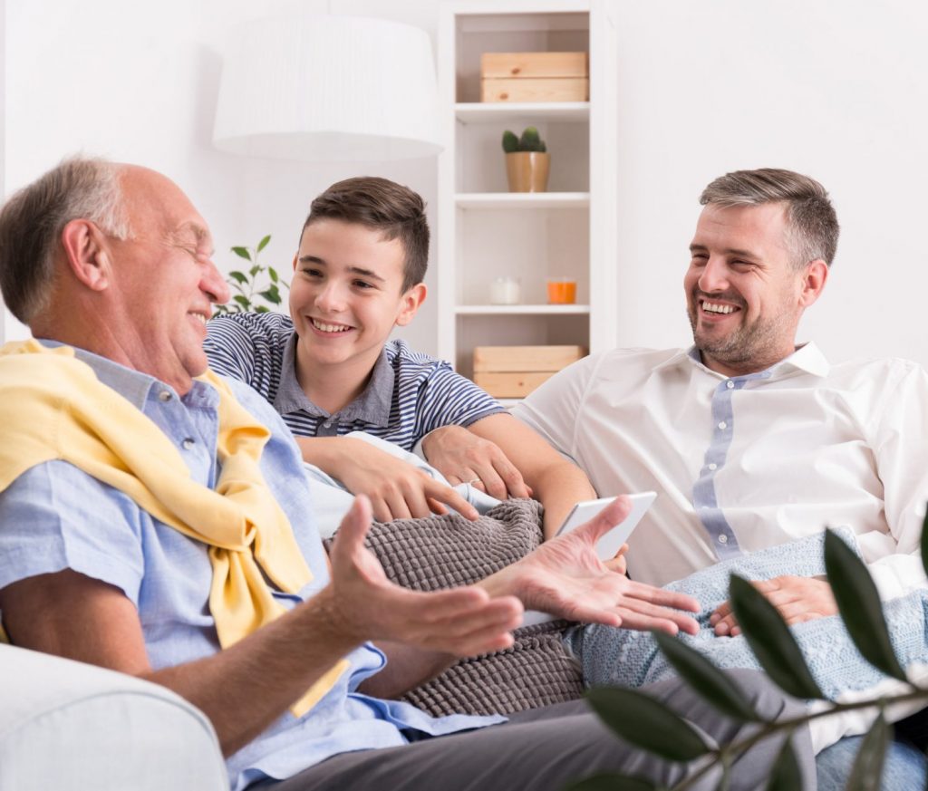 Grandfather telling stories to his son and grandson