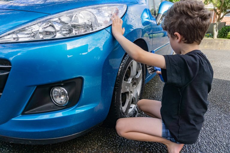 Grandson learning to wash a car